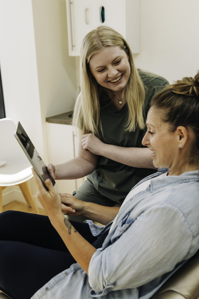 dentist and patient looking at dental report